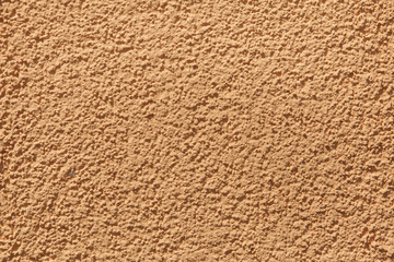 Orange painted stucco wall. Background texture