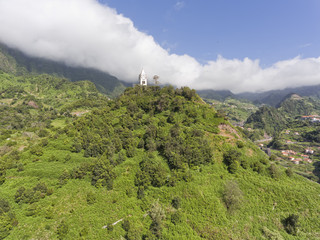 Church on the mountain top with clouds descending to the valley, in picturesque town of Sao...