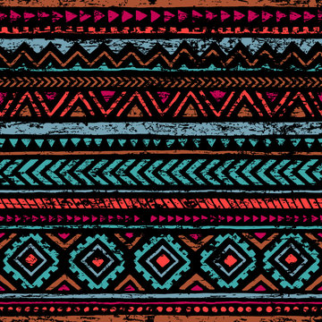 Seamless vintage pattern. Grunge texture. Ethnic and tribal motifs. Blue, orange, red, black and pink colors.