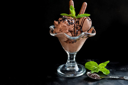 Chocolate ice cream in a cup on a black background