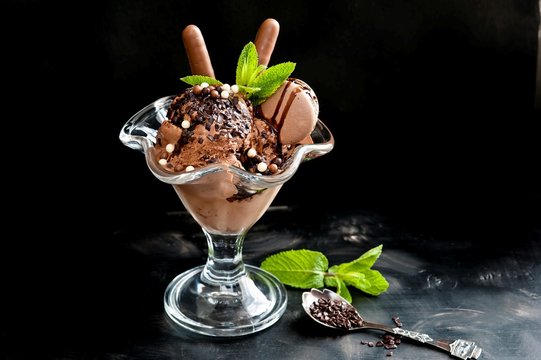 Chocolate ice cream in a cup on a black background