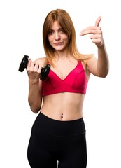 Beautiful sport woman with dumbbells doing coming gesture