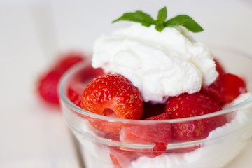 Glass bowl of strawberries with whipped cream. Traditional snack at famous lawn tennis tournament.