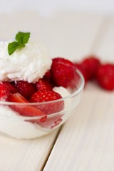 Glass bowl of strawberries with whipped cream. Traditional snack at famous lawn tennis tournament.