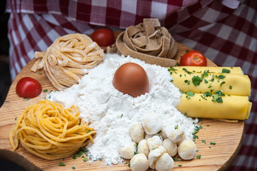 Pasta and dough ingredients on the wooden board