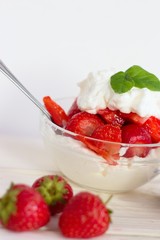 Glass bowl of strawberries with whipped cream. Traditional snack at famous lawn tennis tournament.
