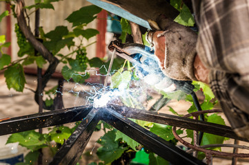 Man welding at his backyard