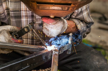 Man welding at his backyard
