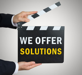 Obraz premium We offer solutions - clapperboard concept