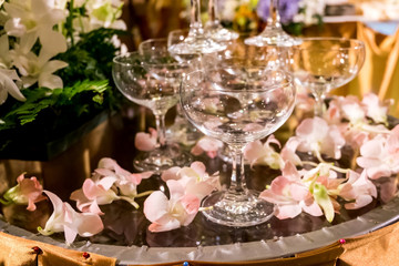 Table setting at a luxury wedding reception party. martini or champagne  glasses in the form of a cascade or pyramid or tower lit light at the wedding party.
