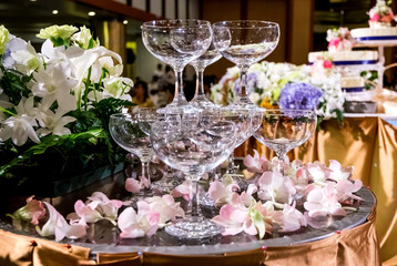 Table setting at a luxury wedding reception party. martini or champagne  glasses in the form of a cascade or pyramid or tower lit light at the wedding party.