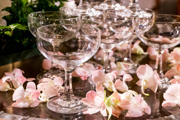 Table setting at a luxury wedding reception party. martini or champagne  glasses in the form of a cascade or pyramid or tower lit light at the wedding party.