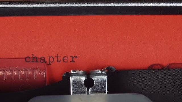 chapter 1 - Typed on a old vintage typewriter. Printed on red paper. The red paper is inserted into the typewriter