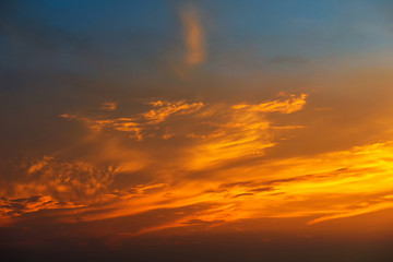 Sunset makes the sky and cloud  a beautiful golden yellow.
