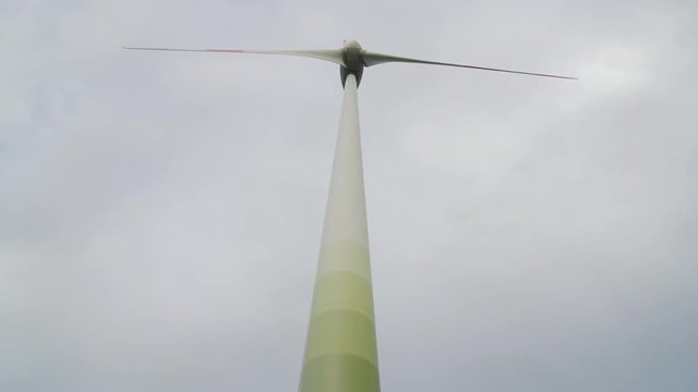 Wind turbine over stormy cloudy sky using renewable energy to generate electrical power. Renewable energy is most environmental way of power generation.