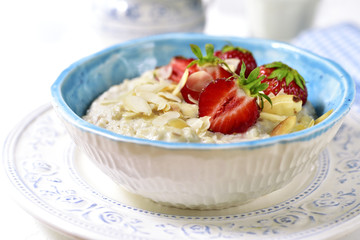 Oat porridge with fresh strawberry for a breakfast.