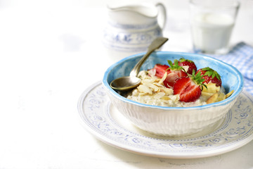 Oat porridge with fresh strawberry for a breakfast.