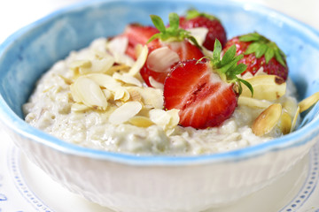 Oat porridge with fresh strawberry for a breakfast.