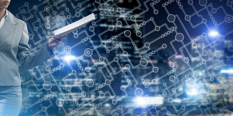 Close of businesswoman against night cityscape background and technology concept