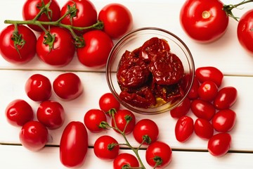 Top view on several types of tomatoes in many shapes, sun dried tomatoes in oil,cherry,regular, etc.