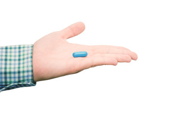 Hand holds the blue pill isolated on white background