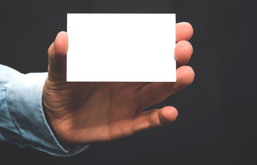 Man holds white blank visit business card