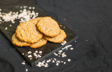 Peanut butter oatmeal cookies against black background