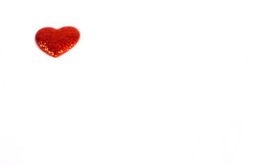 a single red glittery heart with white copy space