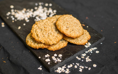 Peanut butter oatmeal cookies against black background
