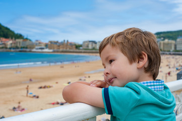 A boy enjoying the seaview of San Sebastian beach