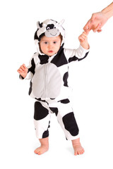 A baby in a fancy dress cow costume on a white background