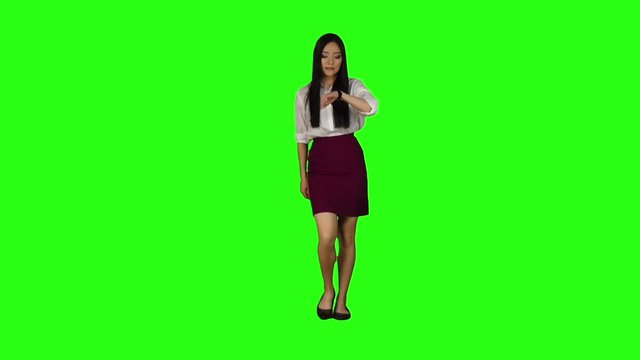 Girl with a phone is running to an important meeting. Green screen. Slow motion