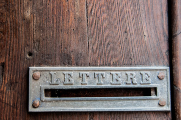 Retro letterbox on old wooden door