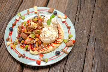 Pancake fruit salad with ice cream