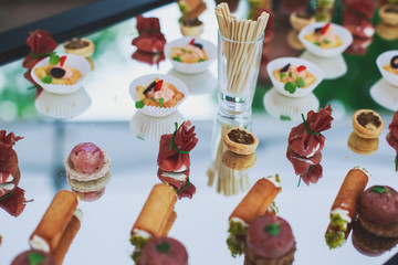 Fototapeta premium Decorated catering banquet table with different food appetizers assortment on a party 