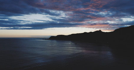 sunset clouds over point, breaker bay, new zealand