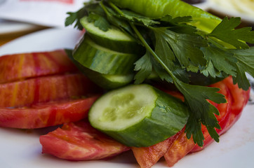 Salad with bell pepper, tomato, cucumber, garlic, herbs