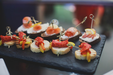 Decorated catering banquet table with different food appetizers assortment on a party
