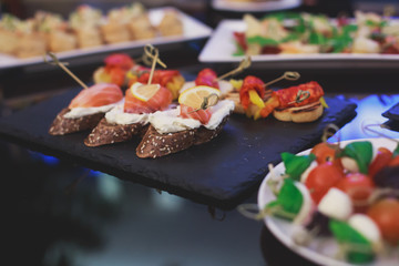 Decorated catering banquet table with different food appetizers assortment on a party
