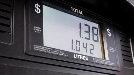 Big screen of rising gas prices on pump screen - Powered by Adobe