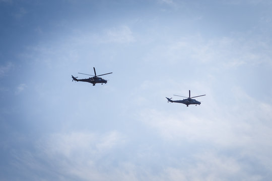 Russsian pilots flying in the sky on mi-28 helicopter night hunter, hovac, at an air show, military parade.