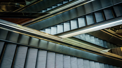 Modern interior design, modern escalators, chrome escalators. Black and White , monochrome, abstract artistic view. Modern art. Steel design. Architecture.