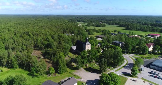 Korppoo, Cinema 4k aerial view towards a church in Korpo town, on a sunny summer day, in the finnish archipelago outside Turku, Varsinais-suomi, Finland