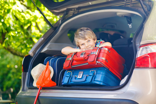 Little Kid Boy Sitting In Car Trunk Just Before Leaving For Vaca