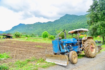 Obraz premium Old Tractor with Mountain View in the Background