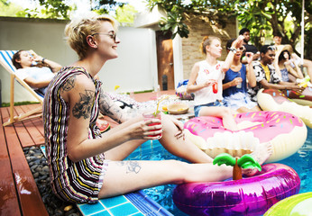 Group of diverse friends enjoying the pool with inflatable tubes