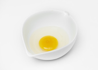 Closeup of fresh organic egg yolk in cup