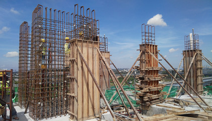 Concrete column steel reinforcement bar at the construction site fabricated by workers.It will be...