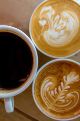 latte art coffee or cappuccino on wooden table background