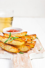 Baked fried potatoes with rosemary and tomato sauce, selective focus